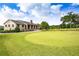 Well-manicured golf course with a stone building and an American flag at 157 Lake Forrest Ne Ln, Atlanta, GA 30342