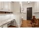 Hallway with a built-in desk, upper cabinets, and a granite countertop and wood bench at 157 Lake Forrest Ne Ln, Atlanta, GA 30342