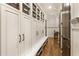 Hallway featuring built-in storage cabinets, baskets, and hardwood floors that provide ample space and organization at 157 Lake Forrest Ne Ln, Atlanta, GA 30342