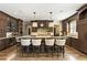 Gourmet kitchen with custom dark wood cabinetry, a large island with seating, and stainless steel appliances at 157 Lake Forrest Ne Ln, Atlanta, GA 30342