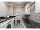 Functional laundry room with modern appliances and stylish granite countertops at 157 Lake Forrest Ne Ln, Atlanta, GA 30342