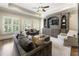 Cozy living room with a wall unit, plush sofas, and plenty of natural light at 157 Lake Forrest Ne Ln, Atlanta, GA 30342