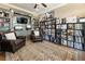 Cozy living room features built-in shelving, leather chairs, and a vintage record collection at 157 Lake Forrest Ne Ln, Atlanta, GA 30342