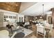 Open-concept living room with hardwood floors, wood ceiling, and comfortable seating arrangement at 157 Lake Forrest Ne Ln, Atlanta, GA 30342