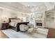 Spacious main bedroom with fireplace, seating area, and decorative chandelier at 157 Lake Forrest Ne Ln, Atlanta, GA 30342