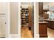 Walk-in pantry provides ample storage with custom shelving, adjacent to the kitchen at 157 Lake Forrest Ne Ln, Atlanta, GA 30342