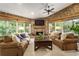 Bright and airy sunroom with a fireplace, large windows, comfortable seating and brick accents at 157 Lake Forrest Ne Ln, Atlanta, GA 30342