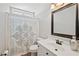 Bathroom with a patterned shower curtain, white vanity, and modern fixtures at 2995 Barimore, Dacula, GA 30019