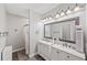 Bright bathroom with double sink vanity, an ornate mirror, and a separated shower/tub area at 2995 Barimore, Dacula, GA 30019