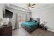 This cozy bedroom boasts a ceiling fan, modern decor, and a serene view from the bright window at 2995 Barimore, Dacula, GA 30019