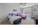 Colorful bedroom with twin beds, vibrant decor, and a window with natural light at 2995 Barimore, Dacula, GA 30019