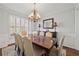 Formal dining room with hardwood floors, chandelier, and wainscoting at 2995 Barimore, Dacula, GA 30019