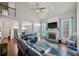 Bright living room with vaulted ceilings, fireplace, hardwood floors, and large leather couch at 2995 Barimore, Dacula, GA 30019