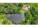 Overhead view of a secluded property featuring a home and a tranquil pond surrounded by a dense forest at 347 Oakhurst Dr, Marietta, GA 30066