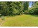 Expansive backyard featuring a lush lawn and mature trees, offering privacy at 347 Oakhurst Dr, Marietta, GA 30066