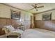 Bright bedroom with two windows, floral wallpaper, and a chair with side table at 347 Oakhurst Dr, Marietta, GA 30066