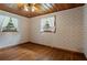 Bedroom with hardwood floors, patterned wallpaper, and bright lighting at 347 Oakhurst Dr, Marietta, GA 30066
