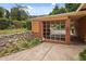 Attached carport featuring a brick wall and a well-manicured garden at 347 Oakhurst Dr, Marietta, GA 30066