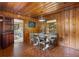 Cozy dining room featuring wood paneling, a modern light fixture, and seating for four at 347 Oakhurst Dr, Marietta, GA 30066