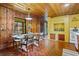 Inviting dining area with wood paneling, dining table, and a view to the backyard at 347 Oakhurst Dr, Marietta, GA 30066