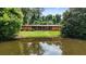 Charming ranch-style home reflected in a peaceful pond surrounded by lush greenery and mature trees at 347 Oakhurst Dr, Marietta, GA 30066
