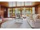 Open living room featuring a wood ceiling, large windows, and comfortable seating at 347 Oakhurst Dr, Marietta, GA 30066