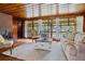 Comfortable living room with a fireplace, wood paneling, hardwood floors and many windows at 347 Oakhurst Dr, Marietta, GA 30066