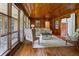 Cozy living room with wood-paneled walls, hardwood floors, and natural light from many windows at 347 Oakhurst Dr, Marietta, GA 30066
