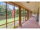 Enclosed porch with brick floor, offering serene pond views and fresh air from ample windows at 347 Oakhurst Dr, Marietta, GA 30066