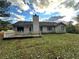 Backyard of house with a small chimney and a patio area with a white railing at 1120 Northern Run, Stockbridge, GA 30281