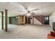 Expansive basement area with paneled walls, ceiling fan, and stairway access at 11270 Stroup Road, Roswell, GA 30075