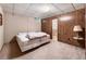 Basement bedroom featuring paneled walls, carpeting, and a full-sized bed at 11270 Stroup Road, Roswell, GA 30075