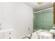 Bathroom features a green tiled shower and a granite vanity top with lots of storage at 11270 Stroup Road, Roswell, GA 30075