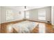 Bright bedroom with hardwood floors, ceiling fan, and multiple windows at 11270 Stroup Road, Roswell, GA 30075