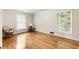 This bedroom features wood floors, neutral paint, lots of natural light and a comfortable chair at 11270 Stroup Road, Roswell, GA 30075