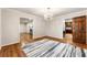 Dining area with decorative rug, chandelier, and hardwood floors, with views to kitchen and living room at 11270 Stroup Road, Roswell, GA 30075
