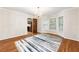 Dining space with a chandelier, hardwood floors, and windows, open to the adjacent kitchen at 11270 Stroup Road, Roswell, GA 30075