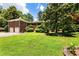 Charming brick home with lush lawn and landscaping offering curb appeal and a private, serene setting at 11270 Stroup Road, Roswell, GA 30075