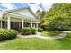 Inviting front porch with brick facade, elegant columns, and a curved walkway at 11270 Stroup Road, Roswell, GA 30075