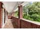 Cozy covered brick front porch with tile flooring and views of the landscaped yard at 11270 Stroup Road, Roswell, GA 30075