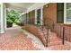 Charming front porch with brick steps, decorative railing, and elegant columns at 11270 Stroup Road, Roswell, GA 30075