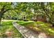 Beautiful walkway leading to a charming brick home with a covered front porch at 11270 Stroup Road, Roswell, GA 30075