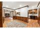 Inviting hallway with hardwood floors, wood trim, and French doors leading to an office and a glimpse of the kitchen at 11270 Stroup Road, Roswell, GA 30075