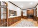 Hallway with hardwood floors, wood trim and view into the kitchen and laundry room with modern washer and dryer at 11270 Stroup Road, Roswell, GA 30075