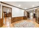 Hallway featuring hardwood floors, wood trim, and multiple doorways leading to other rooms of the house at 11270 Stroup Road, Roswell, GA 30075