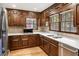 Bright kitchen featuring wood cabinets, stainless steel appliances, and tile backsplash at 11270 Stroup Road, Roswell, GA 30075