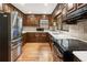 Kitchen with stainless appliances, wood cabinetry, tile backsplash, and ample counter space at 11270 Stroup Road, Roswell, GA 30075