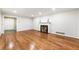 Spacious living room featuring hardwood floors and a cozy fireplace at 11270 Stroup Road, Roswell, GA 30075