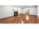 Bright living room showcasing a fireplace, hardwood floors, and a neutral color scheme at 11270 Stroup Road, Roswell, GA 30075