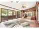 Bright sun room features brick accent walls, tile floors, skylights and a ceiling fan at 11270 Stroup Road, Roswell, GA 30075